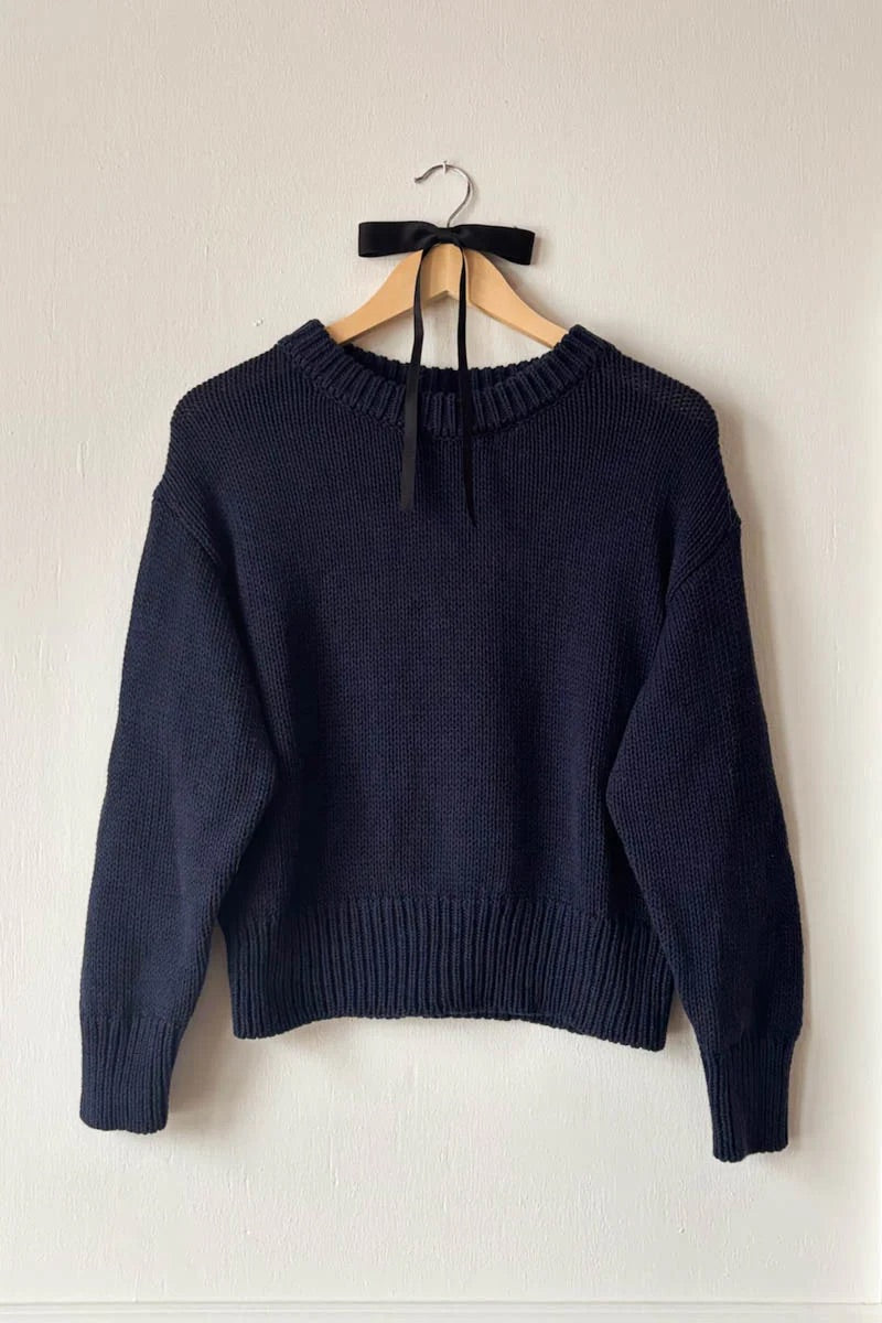 Navy cotton sweater on hanger
