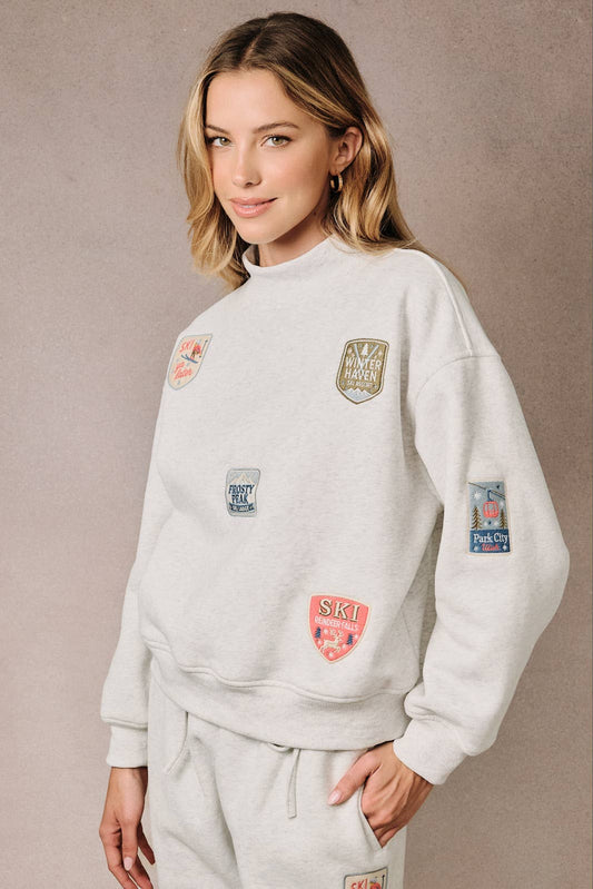 HIGH NECK LONG SLEEVE "SKI PATCHES" SWEATSHIRT